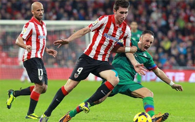 Aymeric Laporte defiende un balón ante un jugador del Barcelona